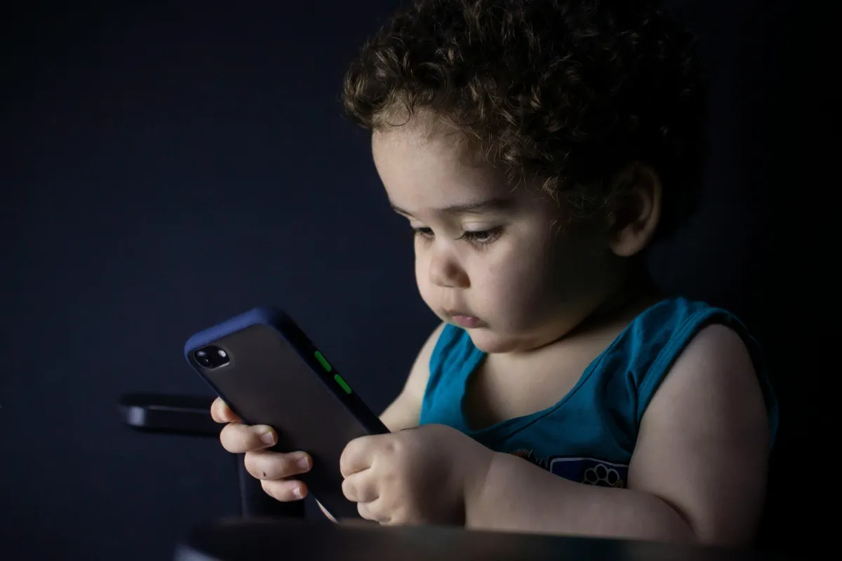 baby looking at mobile phone
