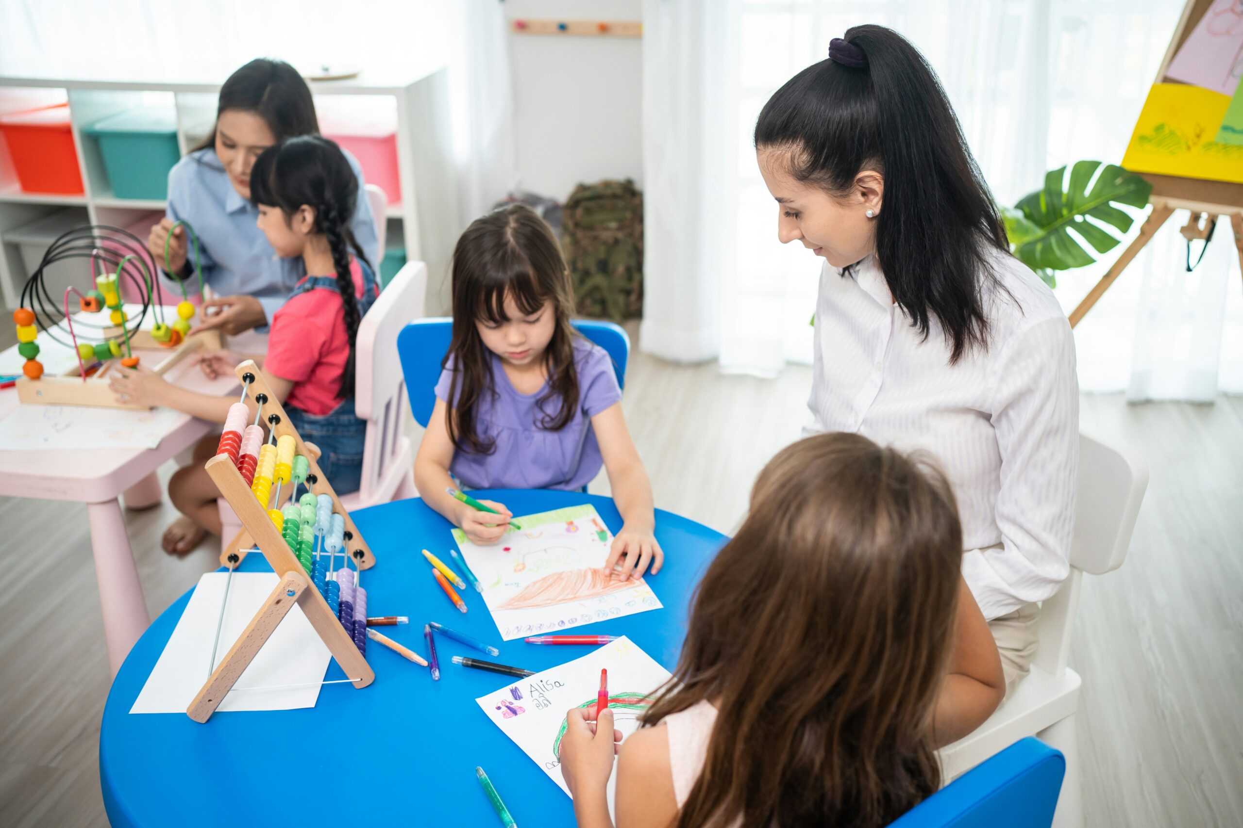 children learning at a table in school